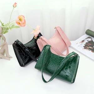 Three elegant crocodile pattern baguette bags in black, pink, and green colors