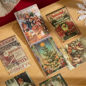 Vintage Christmas washi sticker book with gold foil holiday motifs on wooden background