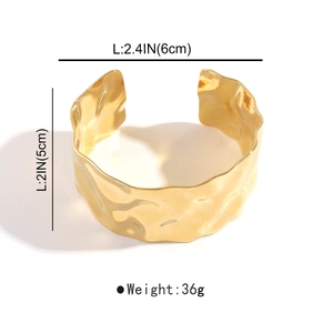 Detail view of gold textured stainless steel cuff bracelet with dimensions 6cm by 5cm