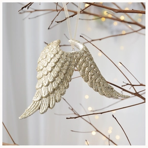 Champagne gold angel wing hanging ornament with glitter finish on a festive tree branch