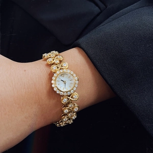 Luxurious gold vintage watch for women featuring pavé diamonds and link bracelet