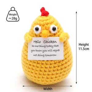 Close-up of a handmade crochet yellow chick with an inspirational card and knit texture