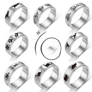 Detail of diverse spinner rings with animals and nature motifs in brushed steel