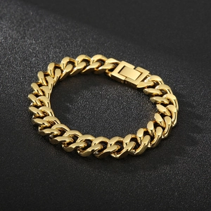 Polished golden stainless steel Cuban link bracelet on premium black textured background