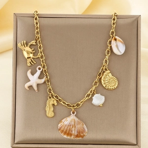 Detail of 18K gold plated ocean charm necklace featuring starfish and seashell pendants