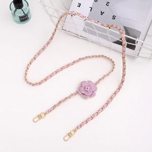 Detail of lavender leather woven metal chain with a pearl camellia flower charm and clasp