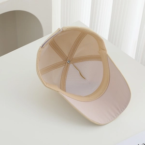 Detailed interior of beige cotton baseball cap showing white reinforced lining and structure