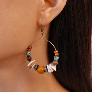 Bohemian dangle earrings with wooden beads and shell accents on a large round hoop