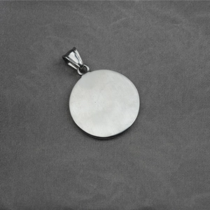 Vintage stainless steel necklace with round star pendant on neutral grey fabric