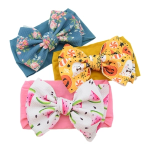 Detailed view of baby headbands with floral, Halloween, and watermelon bow patterns