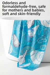 Detail of blue microfiber beach towel with shell prints hanging on a white bathtub