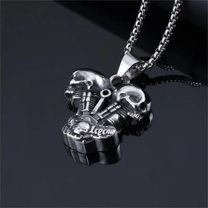 Detailed macro shot of vintage silver skull engine pendant with Legend engraving