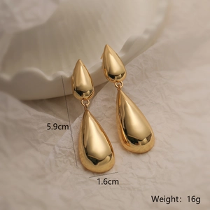 Detail view of gold teardrop earrings with dimensions 5.9cm length and weight 16g