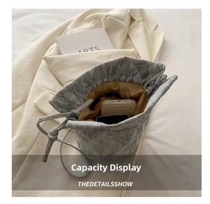 Internal view of grey bucket bag showing large capacity for phone and card holder