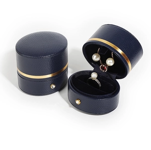 Blue leather jewelry boxes with gold metal trim and velvet lining showing accessories