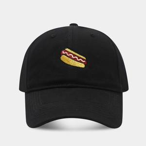 Close-up of hot dog embroidery detail on a black cotton baseball cap with high texture
