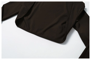 Close-up of the smooth hem stitching and fabric texture on a brown yoga jacket