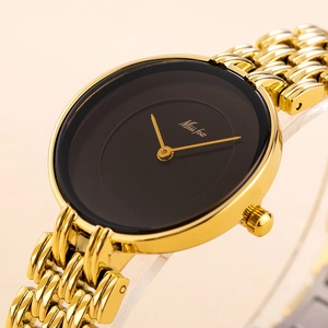 Detail macro shot of a sleek gold metal watch band and minimalist black dial