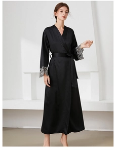 Detailed close-up of luxurious black satin robe featuring intricate silver lace sleeve cuffs