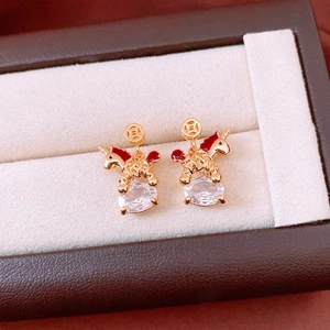 Detail of 18k gold plated unicorn earrings with red enamel and clear cubic zirconia