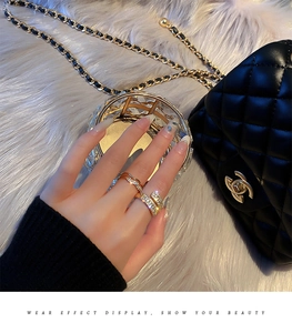 Detail of gold-plated open rings with micro-inlaid zircon shown on a model's hand