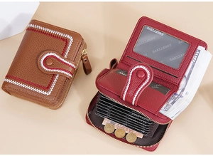 Detail view of compact wallets featuring interior card slots and embroidery stitching