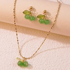 Elegant gold-tone cherry pendant necklace and earring set with green translucent beads