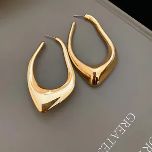 Minimalist teardrop gold earrings with a high-polish mirror finish in a modern style