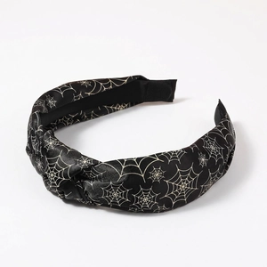 Halloween knot headband with gold spider web pattern on black glossy fabric base