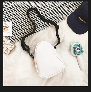Detailed top view of white pear-shaped PU leather crossbody bag with black strap