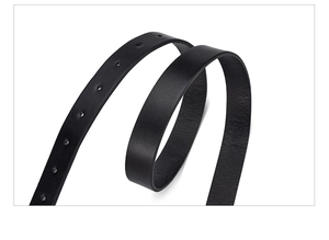Macro shot of black leather belt strap showing precise adjustment holes and matte finish