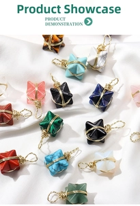 Macro detail of Merkaba star stone pendants wrapped in delicate golden wire