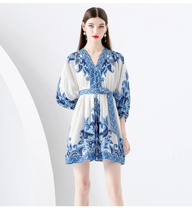 Detailed view of the V-neck and blue vintage floral print on a white mini dress