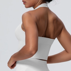 Detailed back view of white halter yoga bra showing seamless knit texture and open back