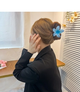 Blue plumeria hair claw clip shown on model for a sweet dopamine-inspired hairstyle