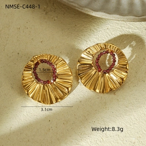 Detail view of golden textured hoop earrings with purple beads and size measurements