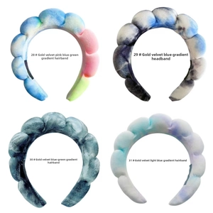 Detail view of thickened gold velvet bubble headbands in four gradient tie-dye colors