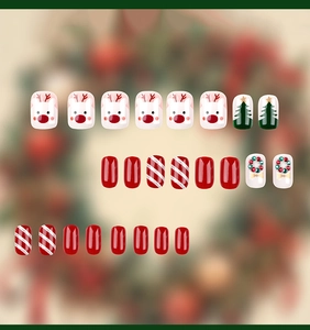 Detailed view of Christmas press-on nails featuring reindeer art and festive holiday patterns