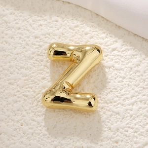 Macro view of 3D bubble letter Z pendant with polished gold finish and balloon texture