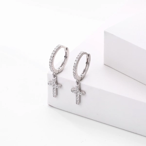 Elegant S925 sterling silver cross earrings with zircon crystals on a white pedestal