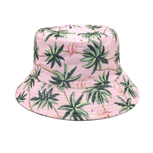 Detail of pink bucket hat with tropical palm tree and flamingo patterns for summer sun protection
