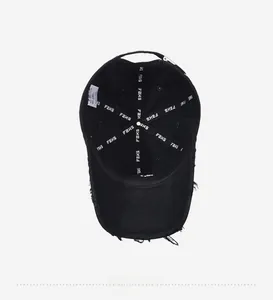 Detailed interior of black distressed cotton baseball cap showing seams and inner tags