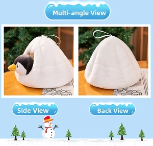 Detail of penguin plush toy in white igloo house with handle and soft velvet fabric