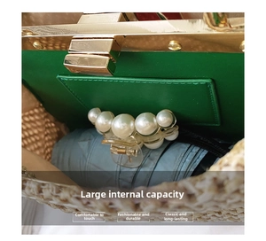 Detail view of woven straw handbag featuring bright green leather lining and golden metal clasp