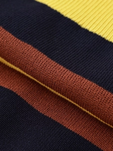 Detailed macro view of the soft knit fabric texture with navy, brown and yellow stripes