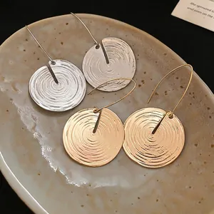 Minimalist textured round metal hoop earrings in gold and silver finishes