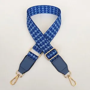 Adjustable teal houndstooth woven strap with gold metal hooks and leather trim