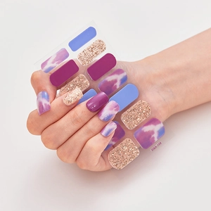 Macro shot of DQ3-106 nail polish wraps featuring purple tie-dye and gold glitter patterns