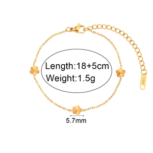 Detail view of 18K gold-plated chain bracelet showing flower charms and length measurement