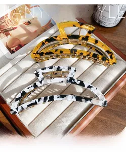 Detail of tortoise shell and marble acetate hair claws in a velvet display tray